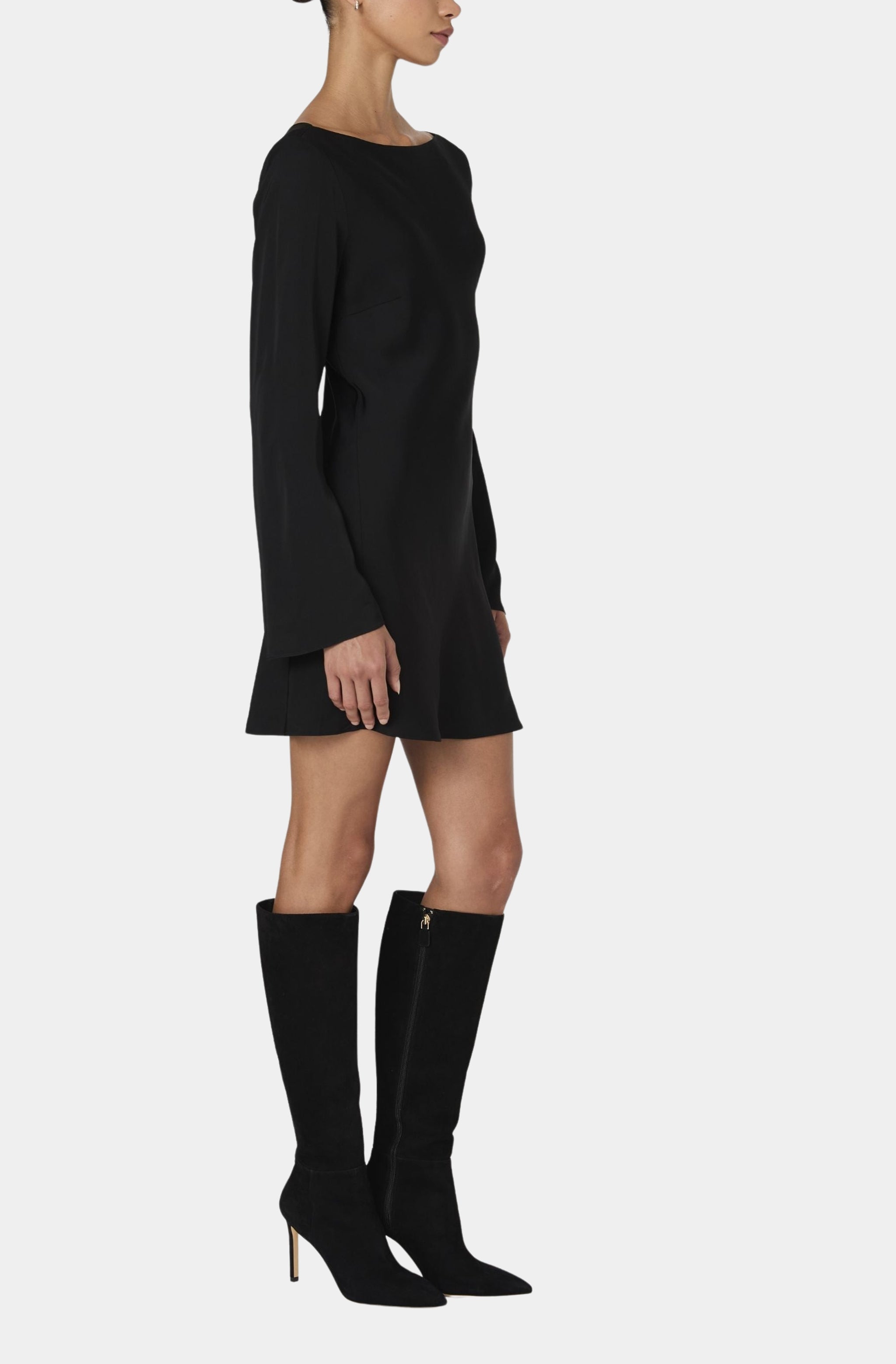 Profile view of black satin mini dress