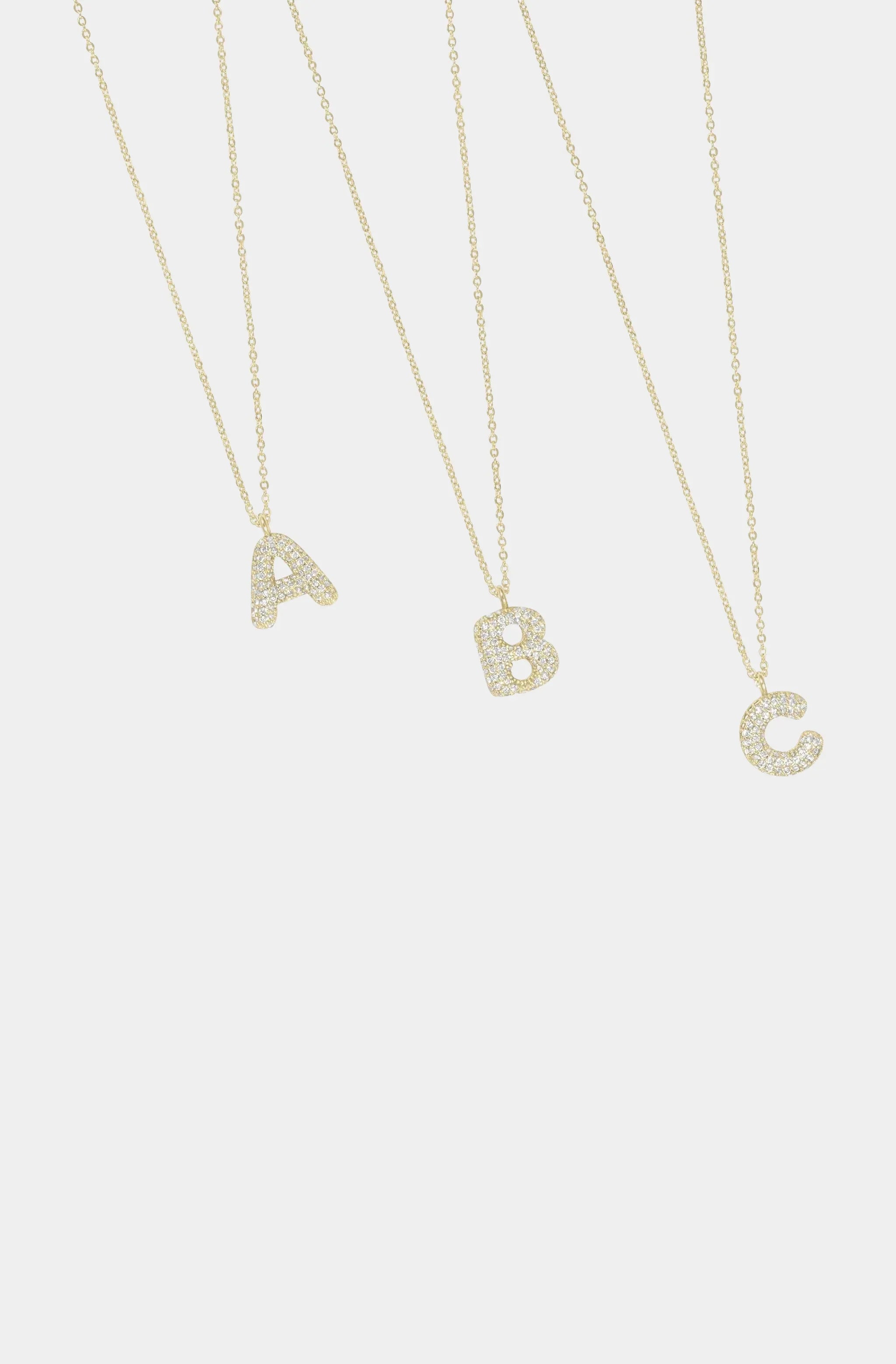 Bubble Letter Necklaces A, B, C on display