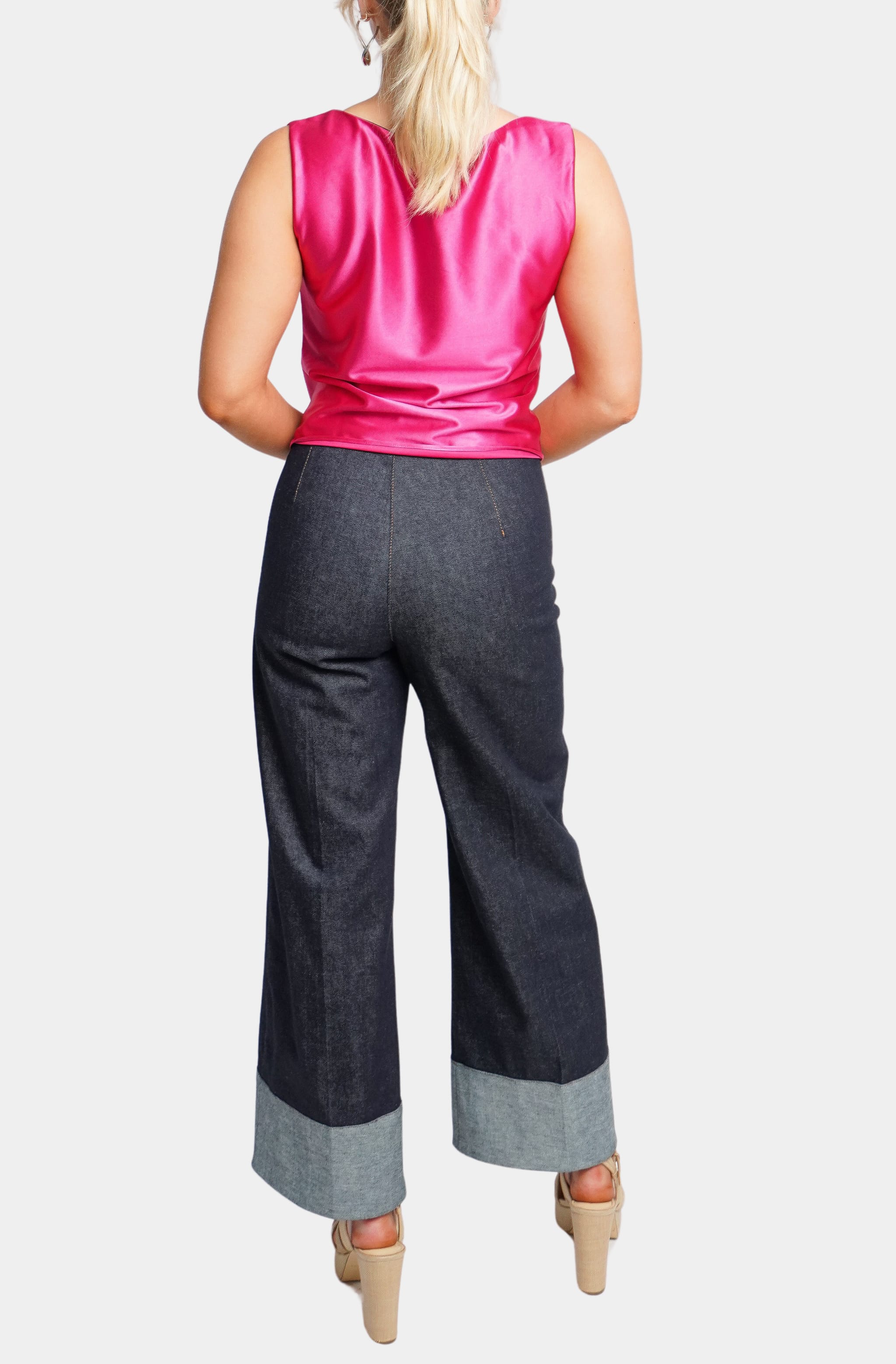 Back view of pink satin Isle Top with denim pants