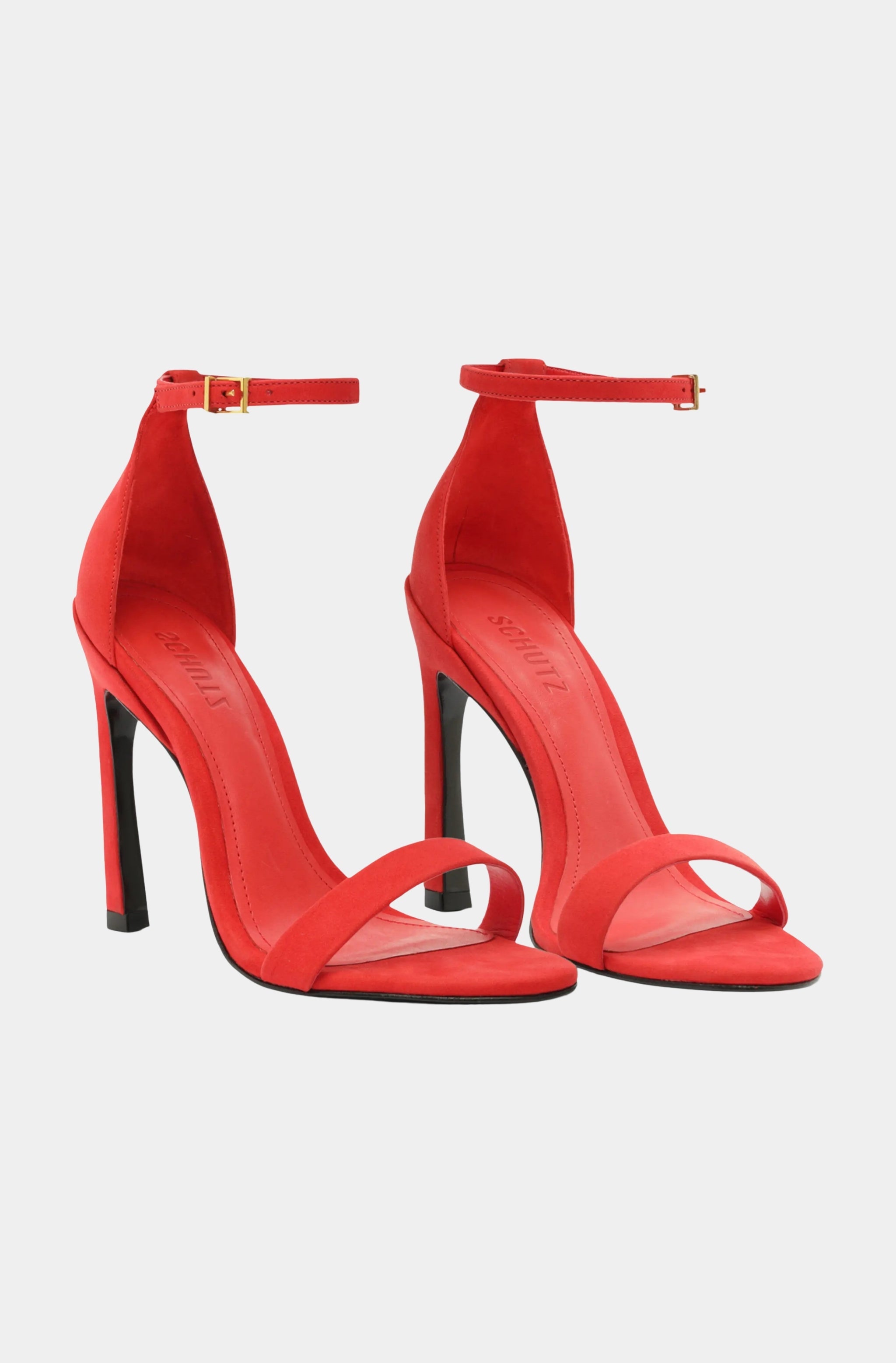 Pair of red Cadey Lee Curve Sandals with slender straps and stiletto heels.